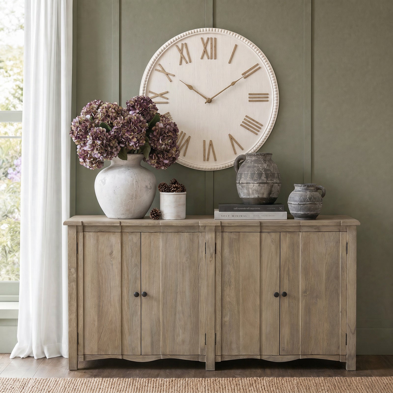 Wooden sideboard with decorative items against a green wall