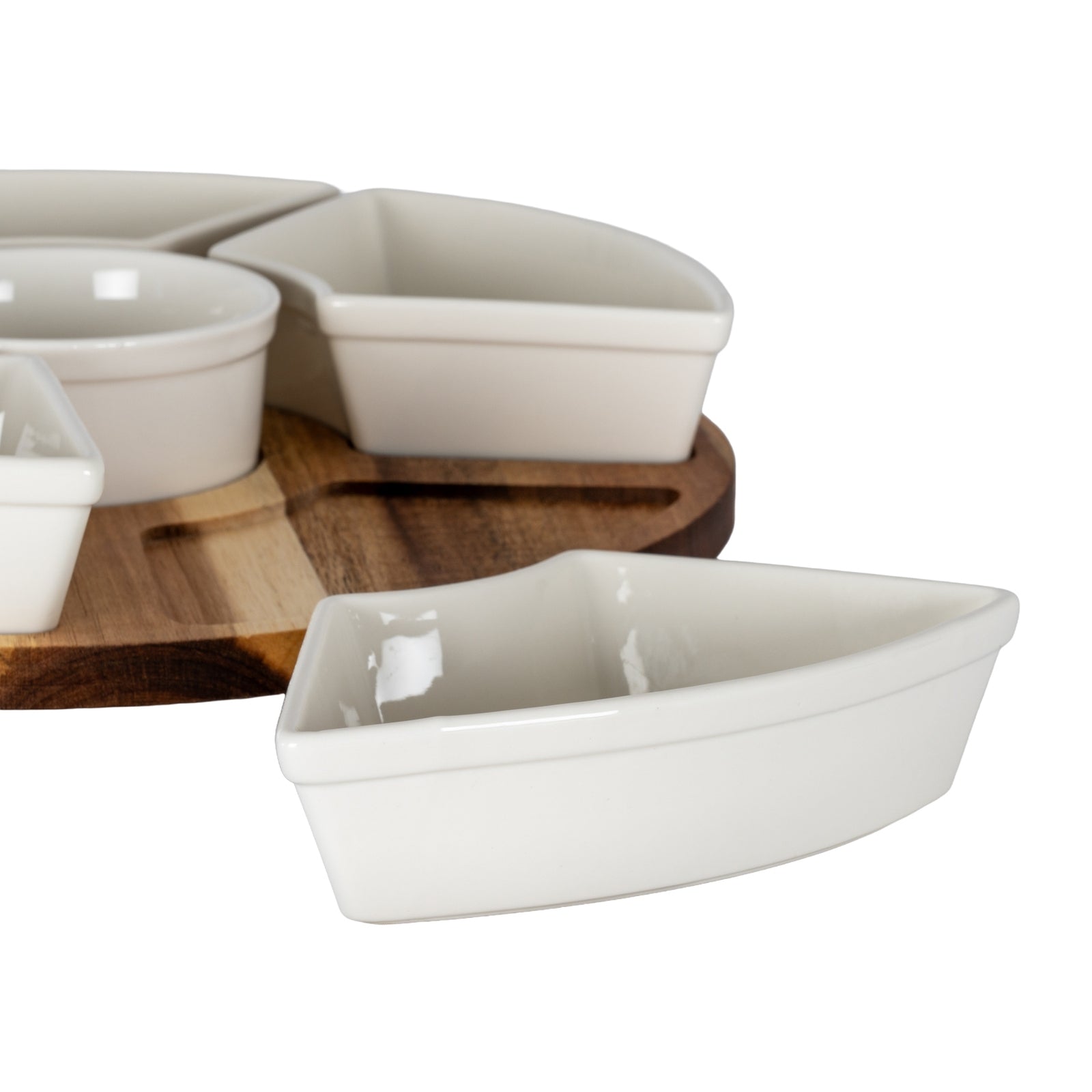 Set of white ceramic dishes on a wooden board with a white background