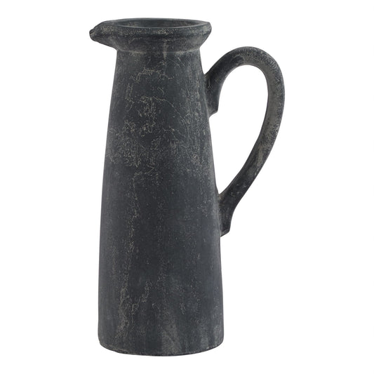 Black ceramic pitcher on a white background