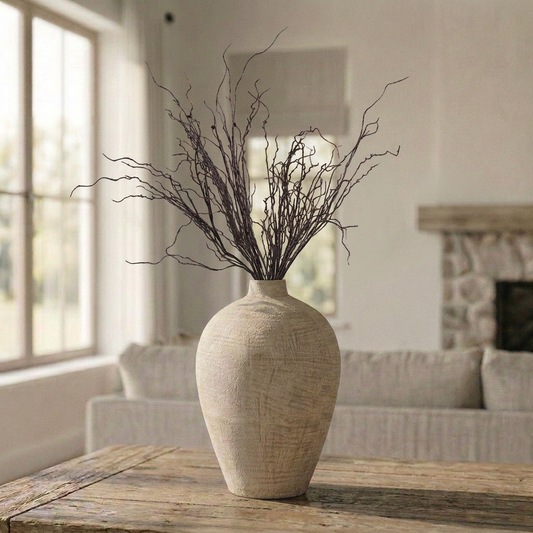 Artificial wispy twig branch stem 130cm styled in a cream ceramic vase on a wooden table in a neutral living room