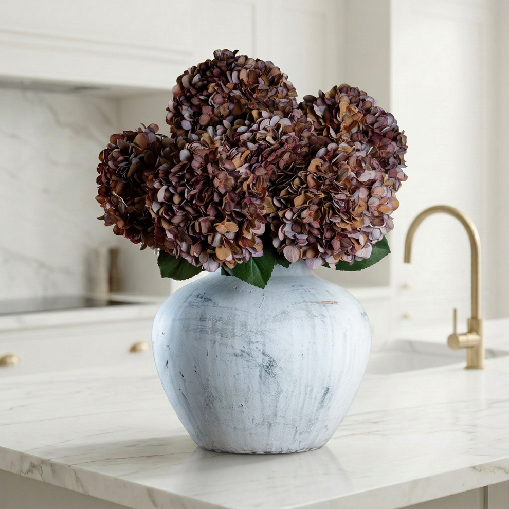 Autumn coffee hydrangea stems in burgundy and orange tones styled as an autumn artificial flower centrepiece