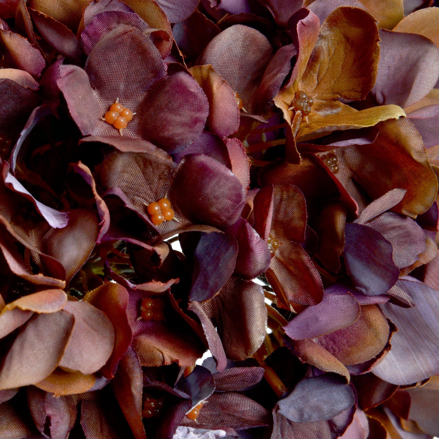 Close-up of a artificial hydrangea petals with purple and orange flowers.