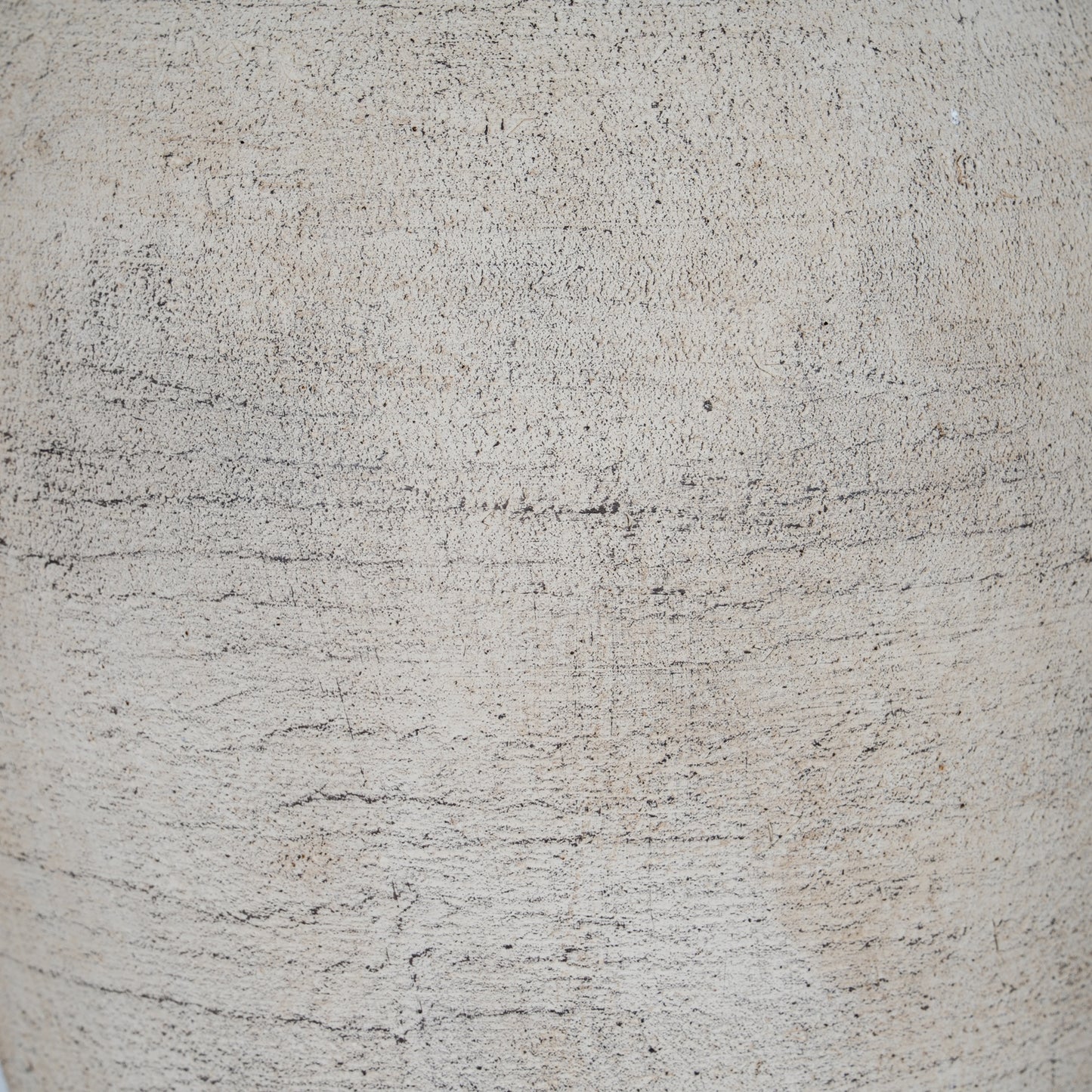 Close-up of a textured beige surface with subtle variations in color.