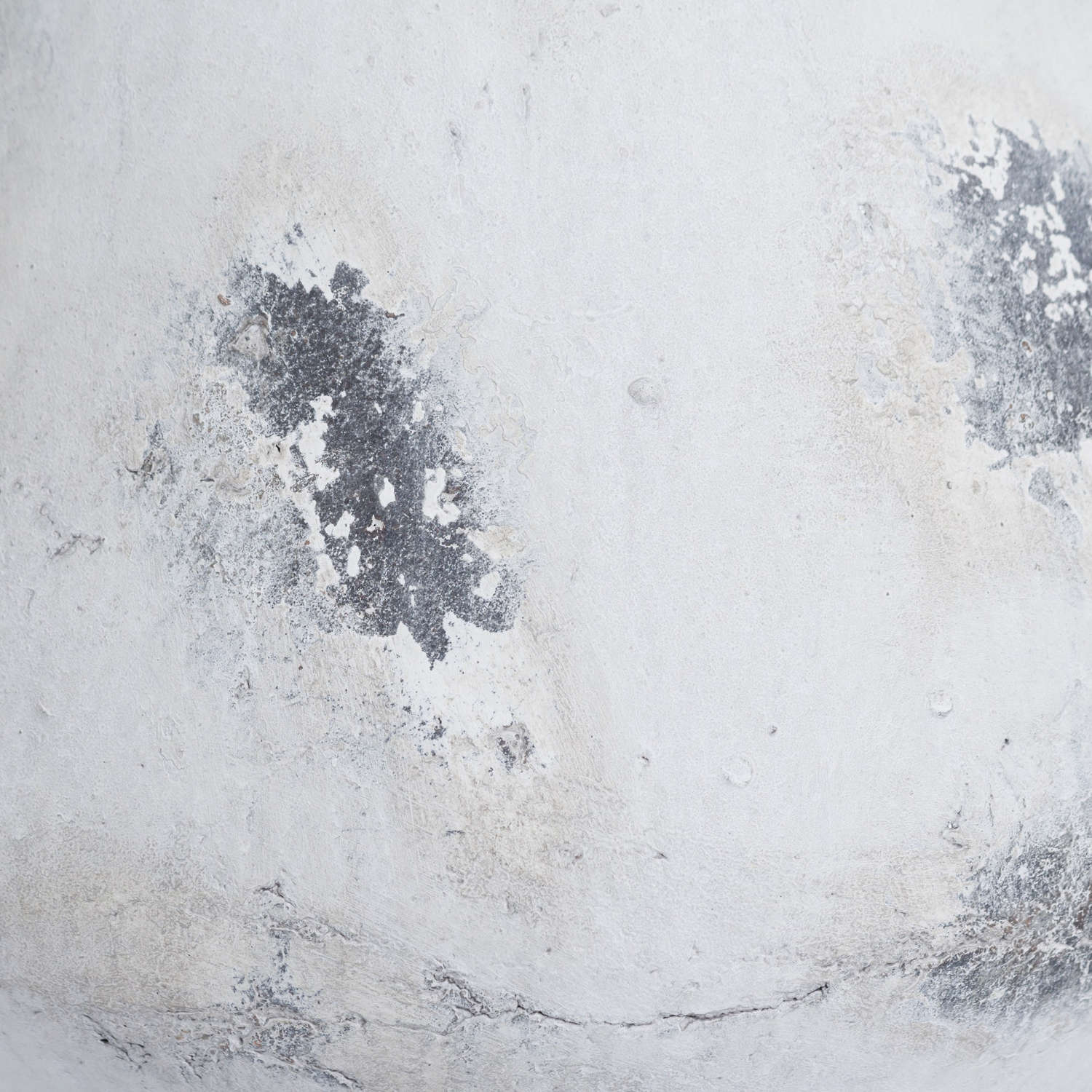 Close-up of a rustic aged look textured white ceramic se 