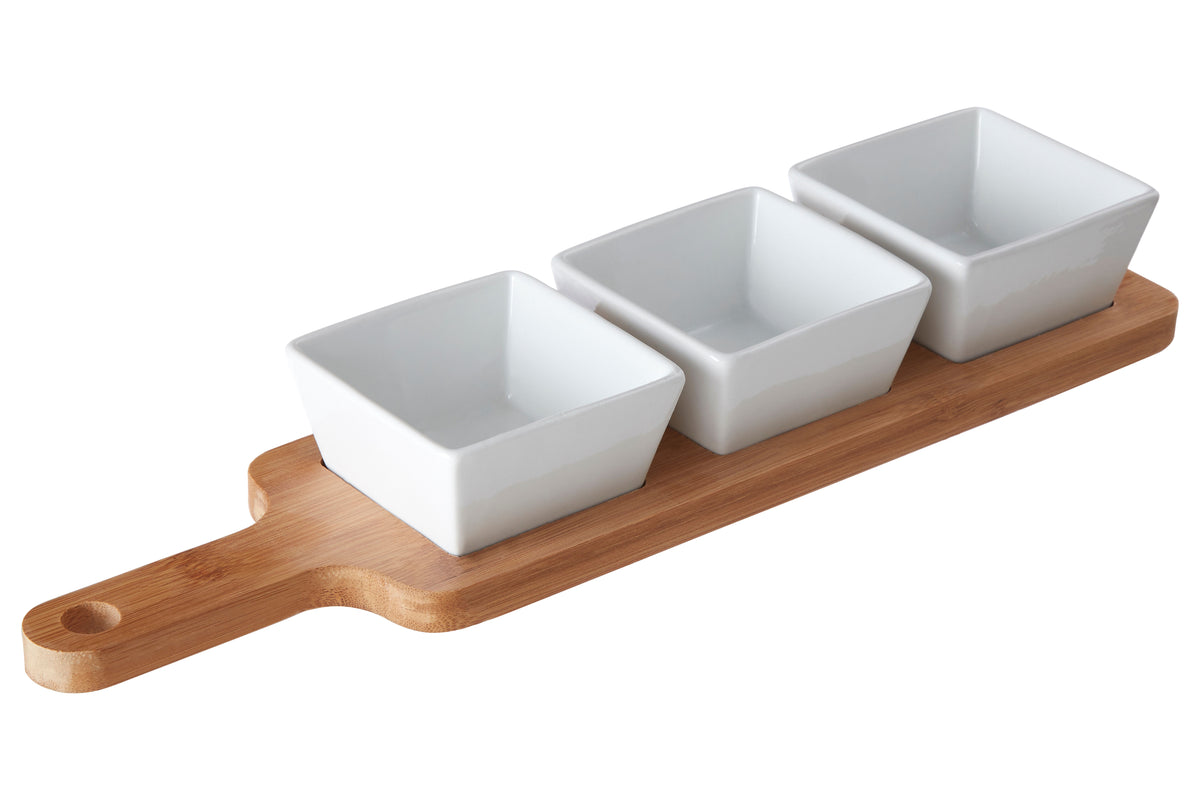 Three square white ceramic dip bowls on a wooden tray against a white background